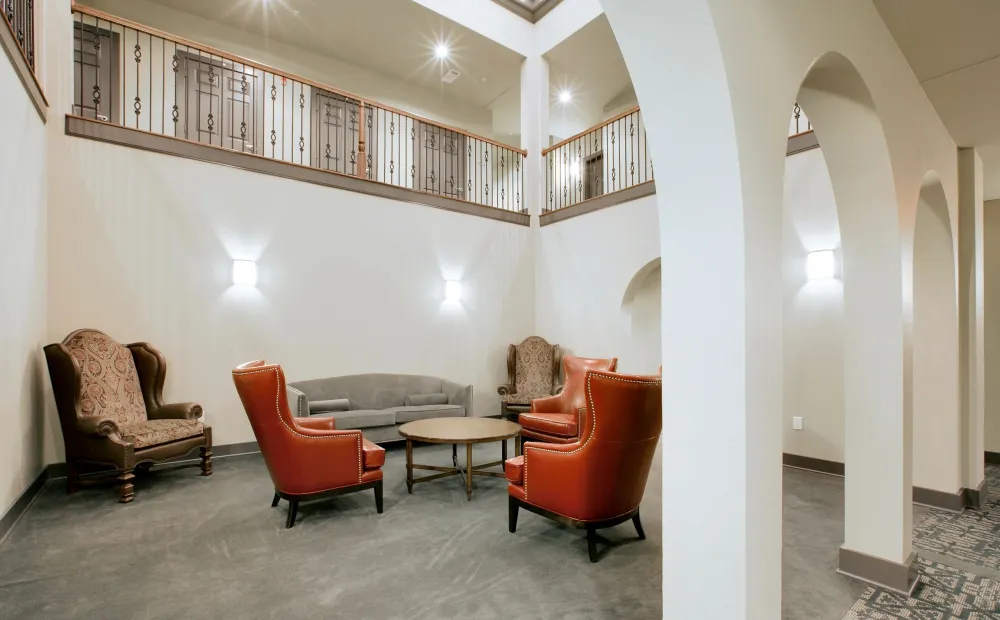 The light-filled central atrium rising through the resident halls at Chateau on Wildbriar Lake