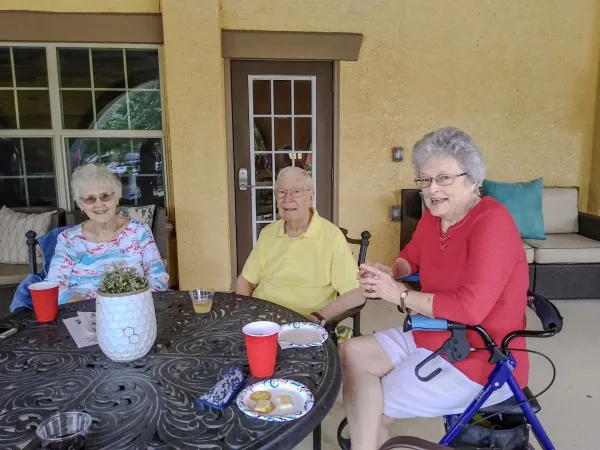 Neighbors enjoying a community cookout on the patio