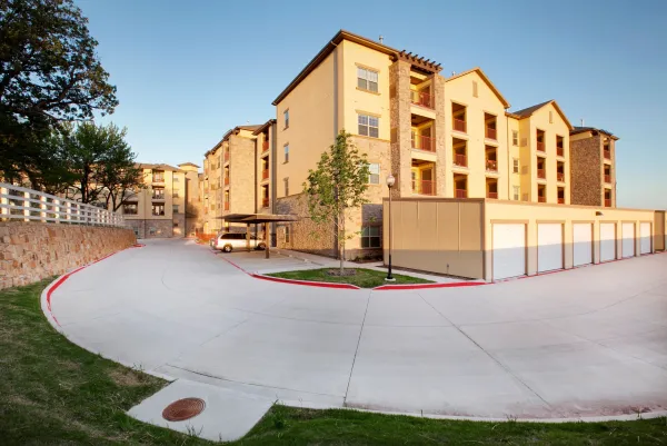 A drive winding through the community, past the resident garages