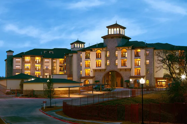 The Chateau's grand façade lit up at dusk