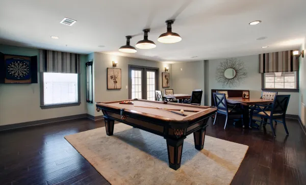 The game room with a billiards table and seating