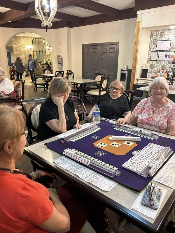 Residents playing a lively game of mahjong together