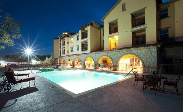 The salt-water swimming pool glowing at dusk beside the veranda