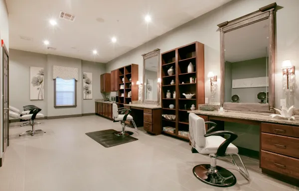 The on-site hair and nail salon with styling chairs and mirrors