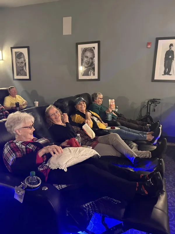 Residents enjoying a film in the community theater
